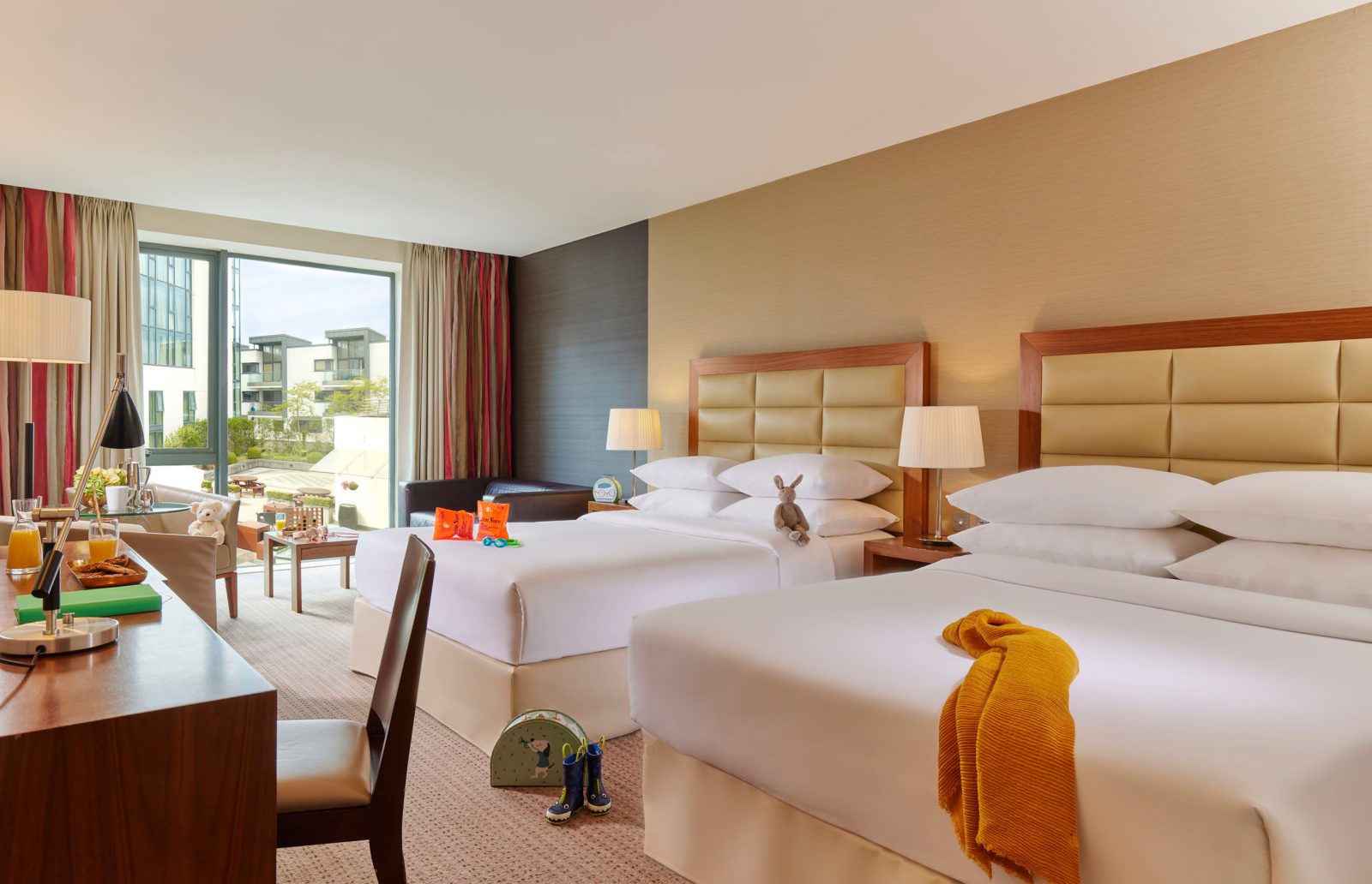 a bedroom with a bed and a table in a room