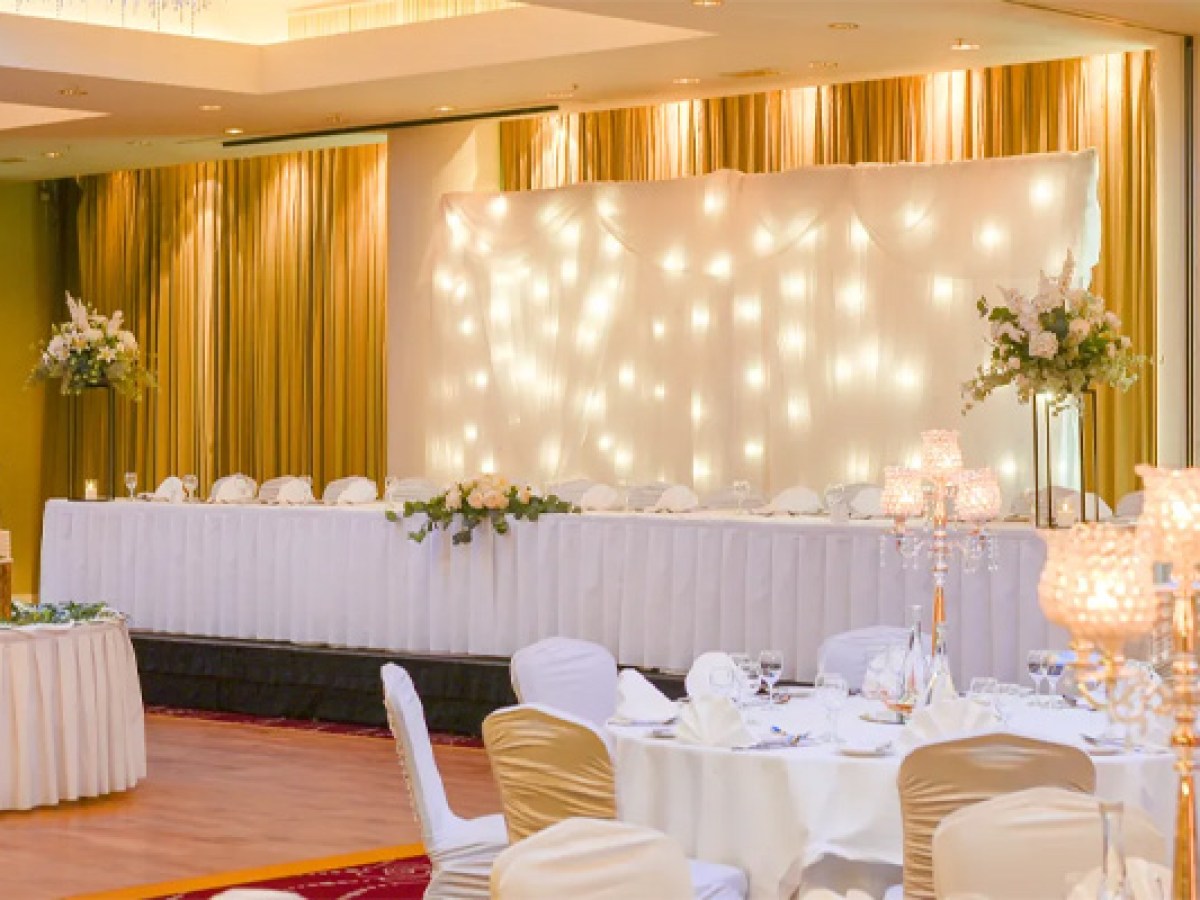 Elegant Sheraton Athlone Hotel wedding reception with decorated tables and a backdrop with string lights