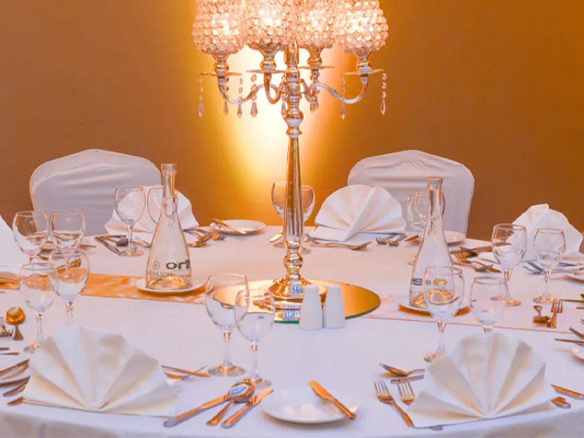 Close-up of elegant table setting at Sheraton Athlone Hotel with white linens and a crystal candelabra centerpiece.